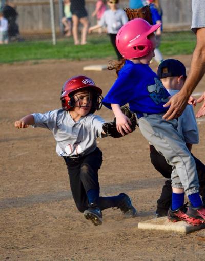 T-ball runner being tagged by fielder